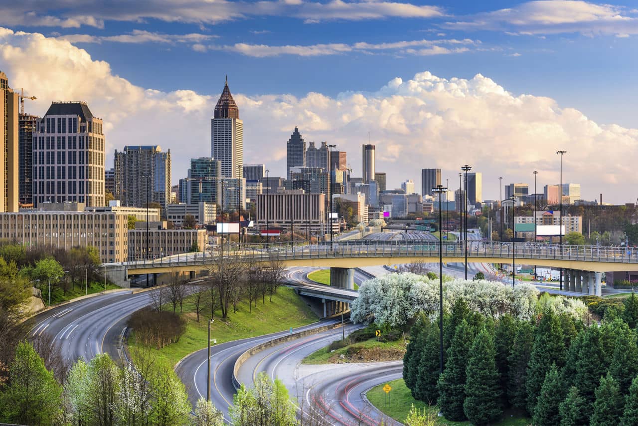 Lindridge-Martin Manor/Lindbergh, GA with highways, blooming trees, and Atlanta skyline featuring Bank of America tower.
